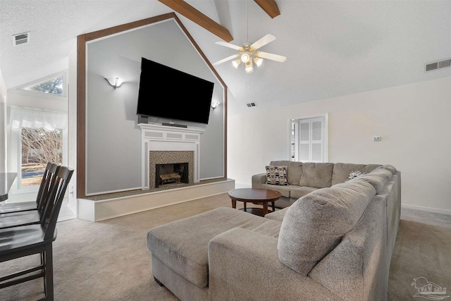 carpeted living room with a textured ceiling, high vaulted ceiling, and ceiling fan