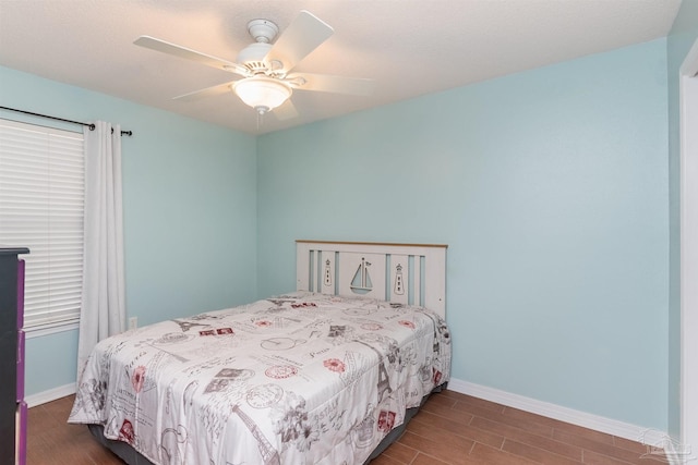 bedroom with dark wood-type flooring and ceiling fan