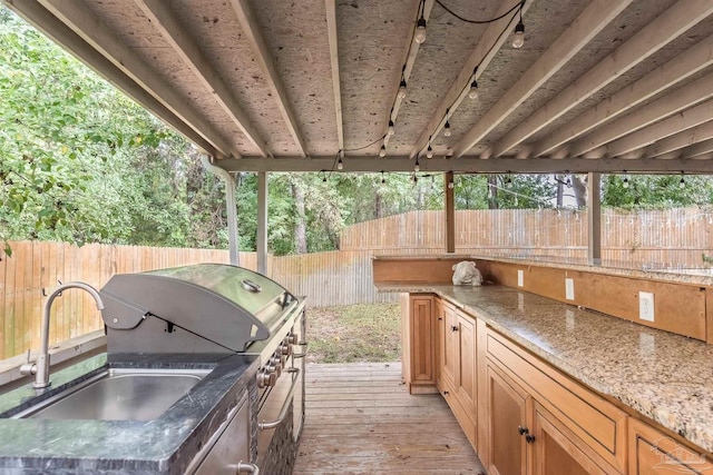 view of patio / terrace with an outdoor kitchen, a wooden deck, and sink