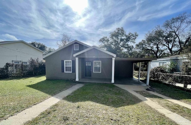 view of front of property with a front yard and a carport