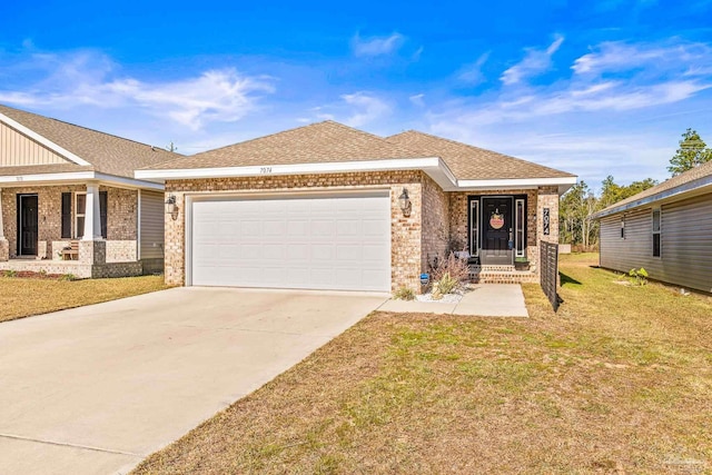 view of front of home with a front yard and a garage