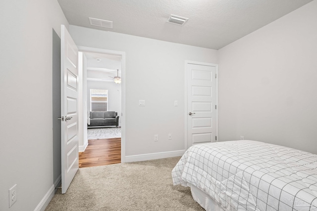 carpeted bedroom featuring a textured ceiling