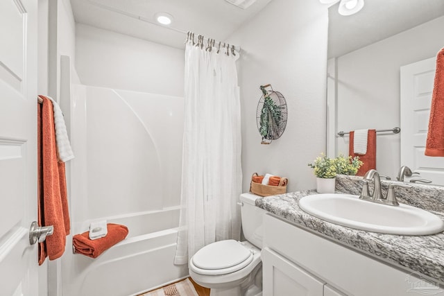 full bathroom with hardwood / wood-style floors, vanity, shower / bath combo, and toilet