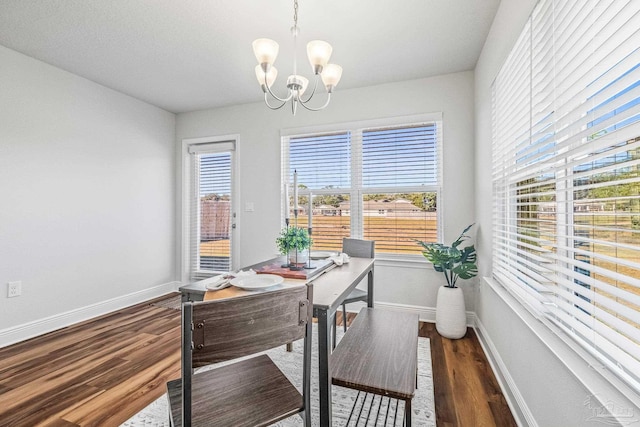 home office featuring dark hardwood / wood-style floors and a notable chandelier