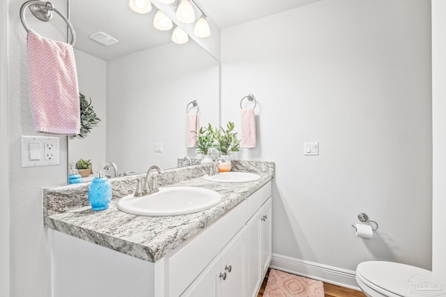 bathroom featuring vanity and toilet