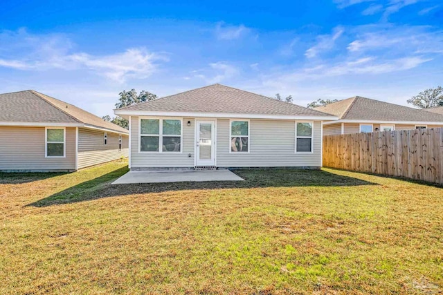 rear view of house with a patio area and a lawn