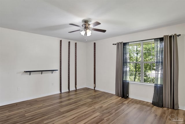 unfurnished room with ceiling fan and wood-type flooring