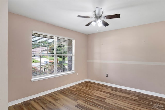 spare room with wood-type flooring and ceiling fan