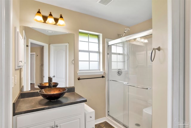 bathroom with walk in shower and vanity