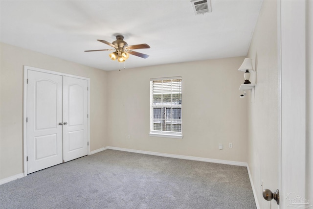 unfurnished bedroom featuring ceiling fan, carpet floors, and a closet