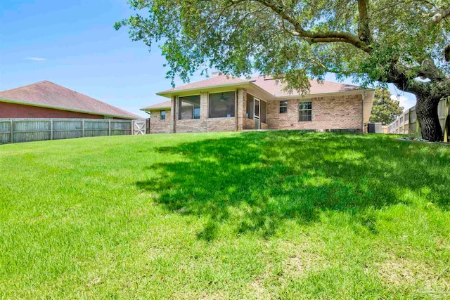 back of house with a lawn