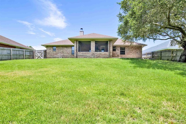 back of property featuring a yard