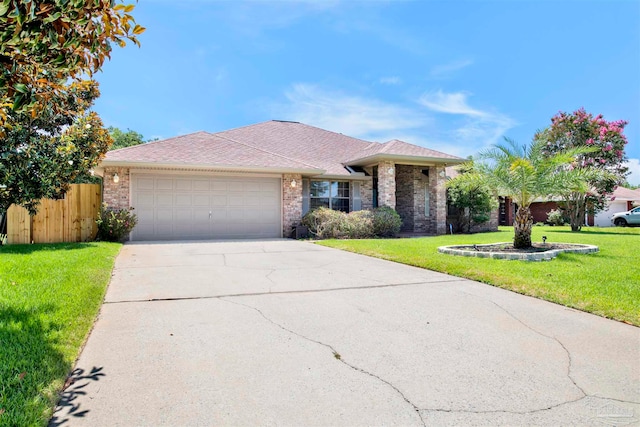 single story home with a garage and a front lawn