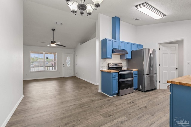 kitchen featuring wood counters, ceiling fan with notable chandelier, stainless steel appliances, and blue cabinets