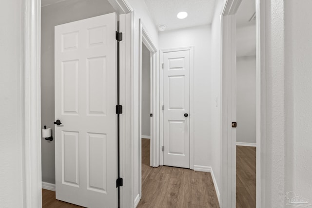 corridor featuring hardwood / wood-style floors