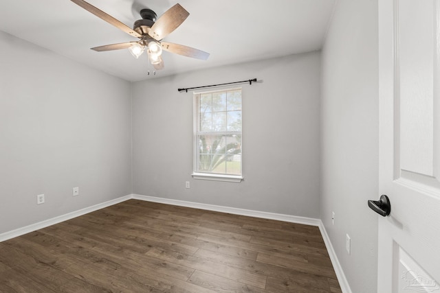 empty room with dark hardwood / wood-style floors and ceiling fan