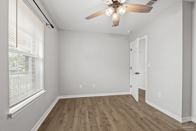 spare room with wood-type flooring and ceiling fan