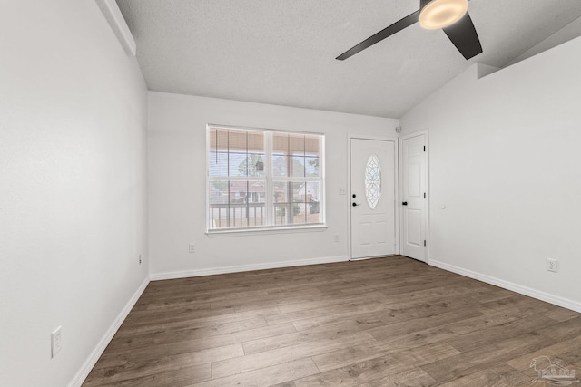 entrance foyer with ceiling fan, lofted ceiling, dark hardwood / wood-style flooring, and a textured ceiling