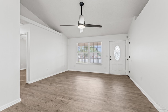 entryway with hardwood / wood-style flooring, ceiling fan, and lofted ceiling