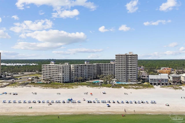 drone / aerial view featuring a beach view and a water view