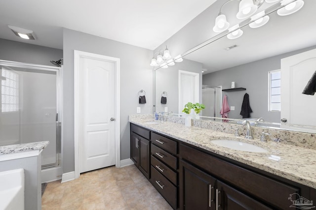 bathroom with visible vents, a stall shower, and a sink