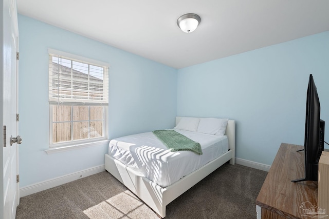 bedroom featuring baseboards and carpet