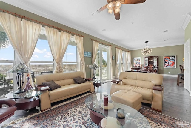 living room with ceiling fan, baseboards, dark wood-style flooring, and crown molding