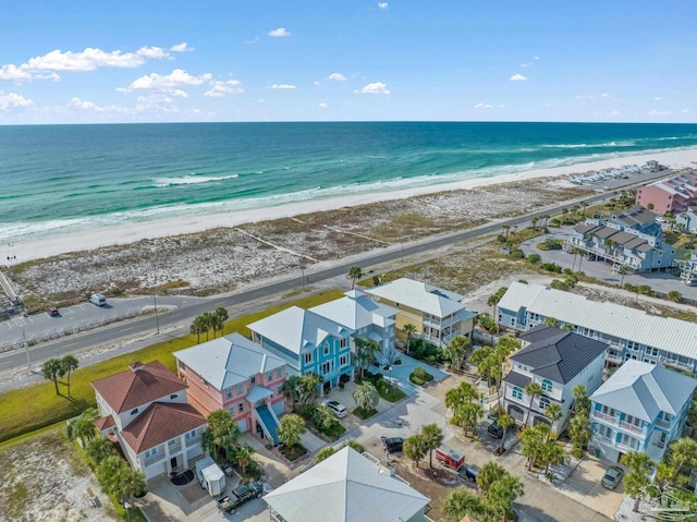 birds eye view of property featuring a beach view and a water view