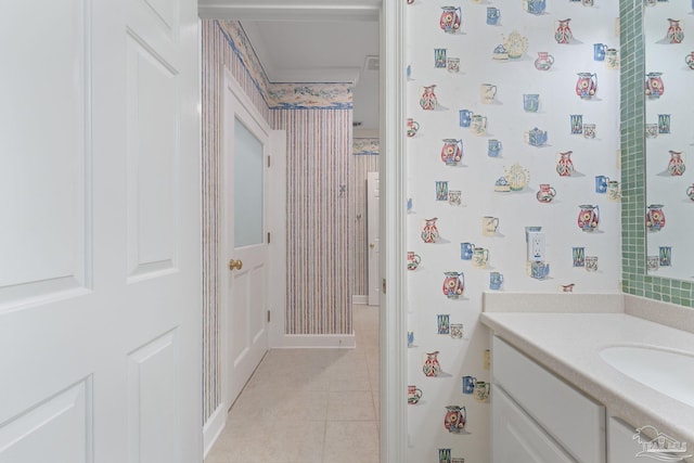 bathroom featuring tile patterned floors, vanity, baseboards, and wallpapered walls