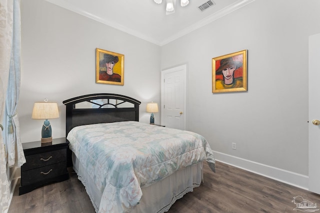 bedroom with dark wood-style flooring, visible vents, crown molding, and baseboards