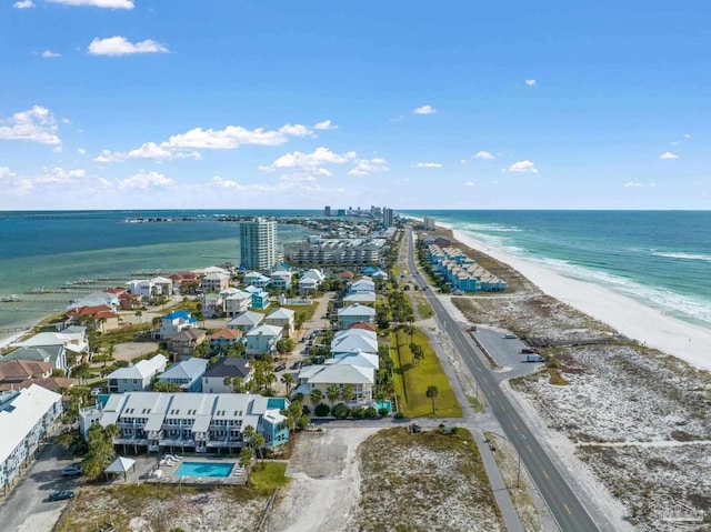 birds eye view of property featuring a water view and a beach view