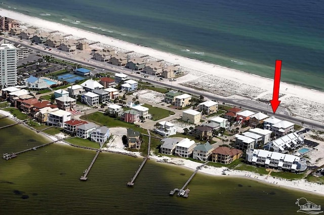 drone / aerial view with a water view and a view of the beach