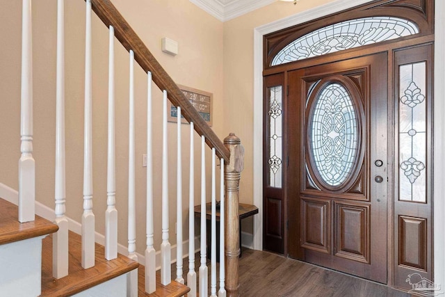 foyer with dark wood finished floors, crown molding, and stairs