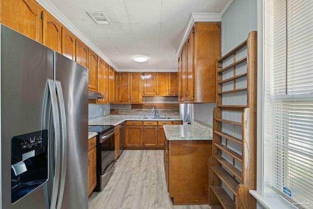 kitchen with visible vents, under cabinet range hood, stainless steel appliances, light wood-style floors, and brown cabinetry