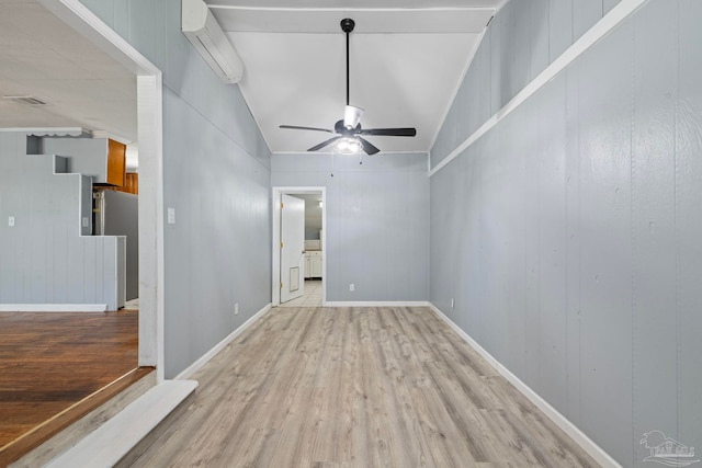 empty room featuring light wood-type flooring, an AC wall unit, ceiling fan, and visible vents