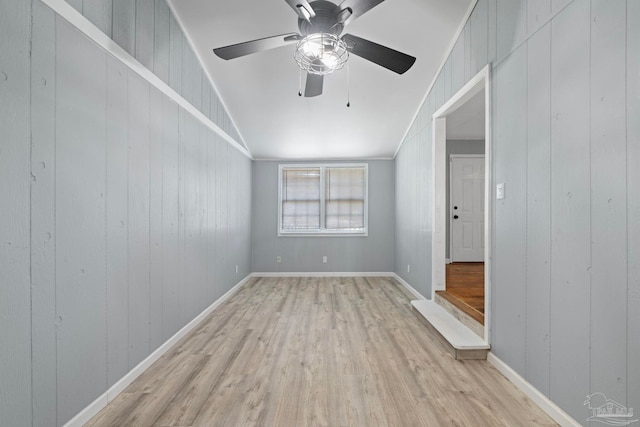 unfurnished room featuring baseboards, crown molding, a ceiling fan, and light wood finished floors