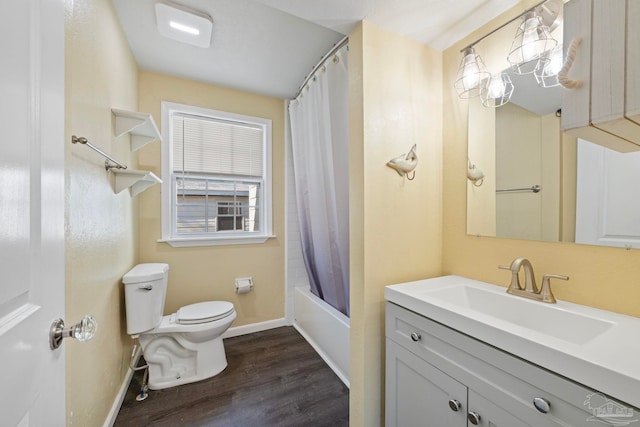 bathroom with baseboards, toilet, wood finished floors, vanity, and shower / bathtub combination with curtain