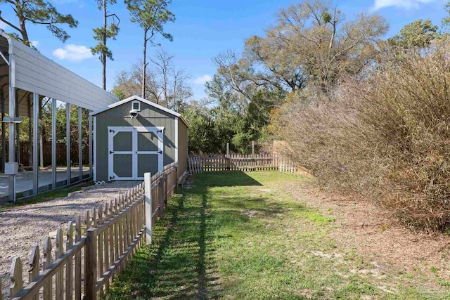 view of yard with a storage shed, fence, and an outdoor structure