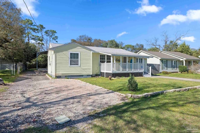 view of front of house with fence, driveway, covered porch, a front lawn, and crawl space