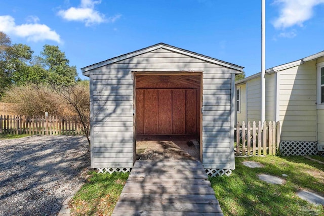 view of shed featuring fence