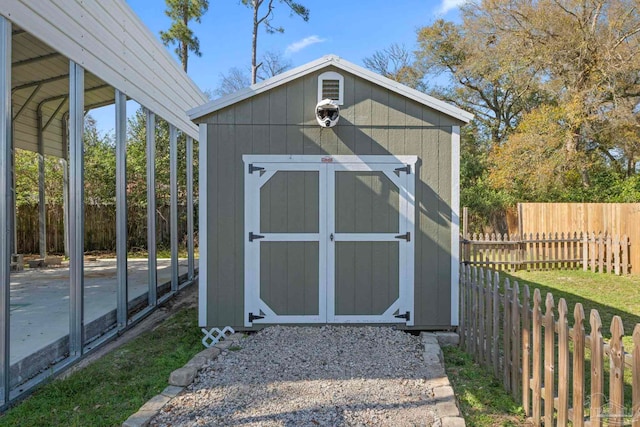 view of shed with a fenced backyard