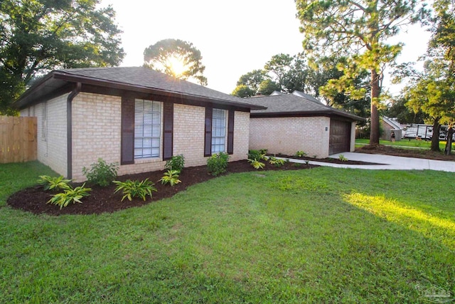 view of side of home with a yard and brick siding