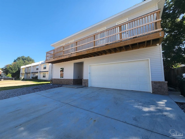 view of front of house featuring a balcony and a garage