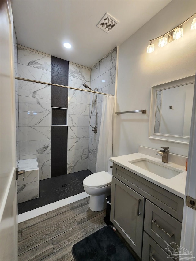 bathroom with a shower with shower curtain, vanity, and toilet