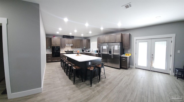 dining space featuring french doors and light hardwood / wood-style flooring