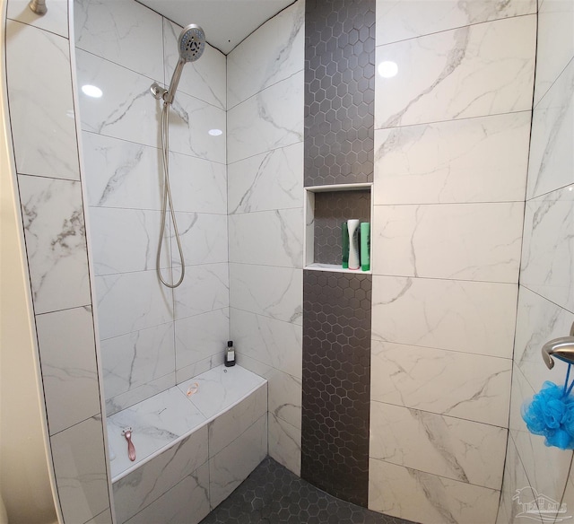 bathroom with tiled shower