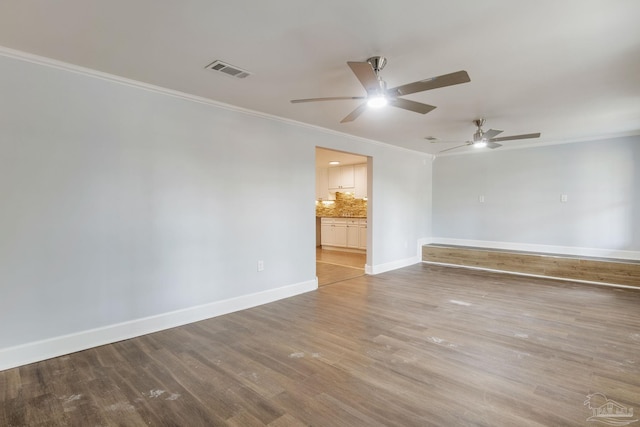 unfurnished room with ceiling fan, ornamental molding, and wood-type flooring