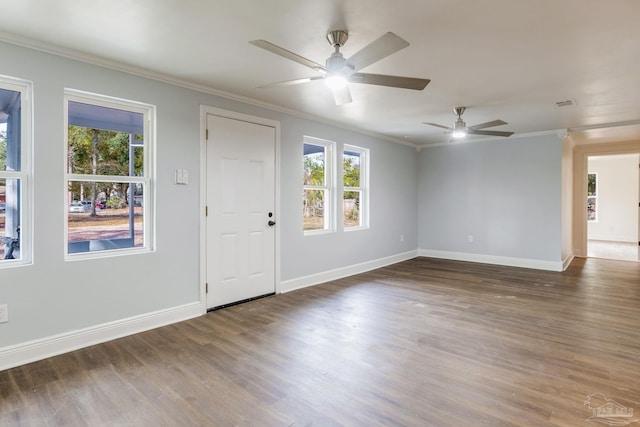 unfurnished room with crown molding, dark wood-type flooring, and ceiling fan