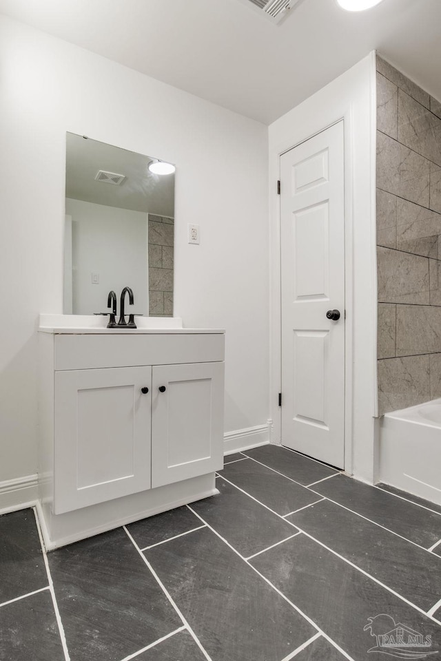 bathroom with vanity and tiled shower / bath combo