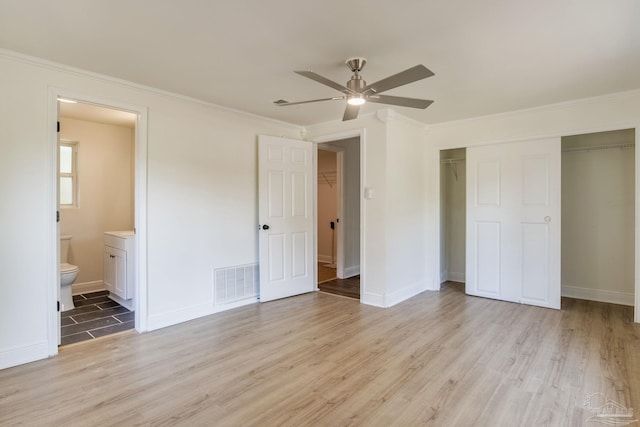 unfurnished bedroom with a closet, ornamental molding, and light hardwood / wood-style flooring